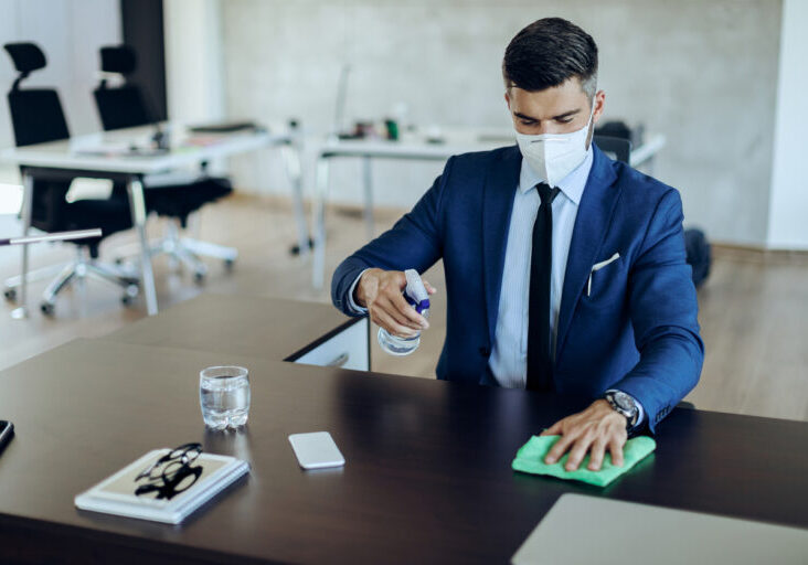 Businessman-spraying-his-desk