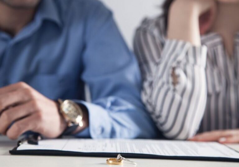 Couple with divorce paperwork and rings