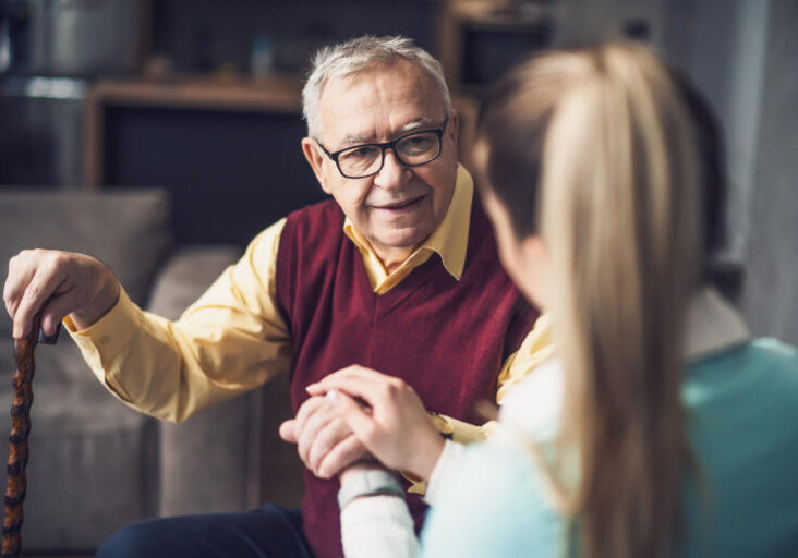 Home nurse caregiver A man and woman holding hands