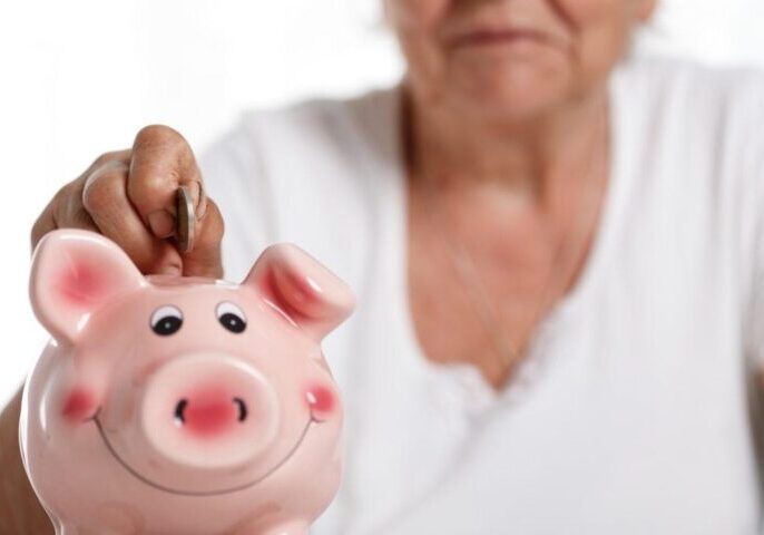 Elderly-woman-with-piggy-bank-1080x675