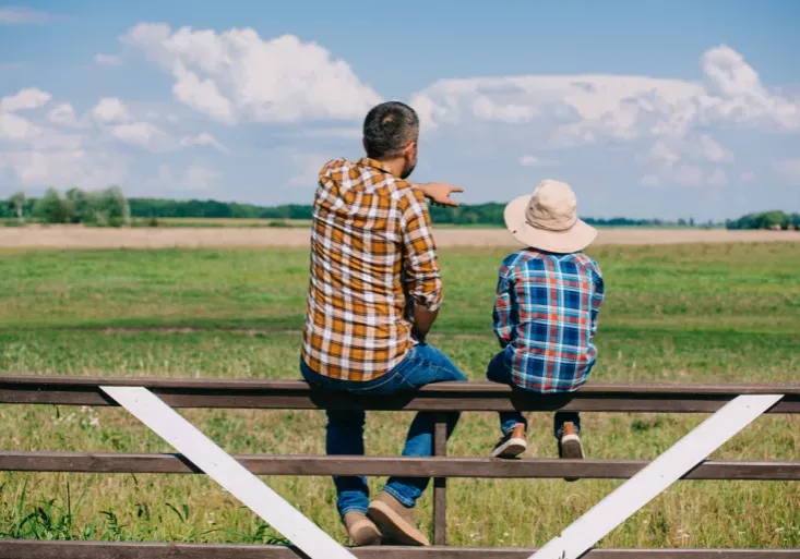 Father showing young son the land that will one day be his.