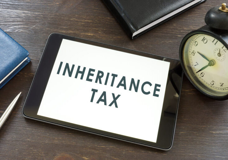 Inheritance tax words on the tablet and notepad.