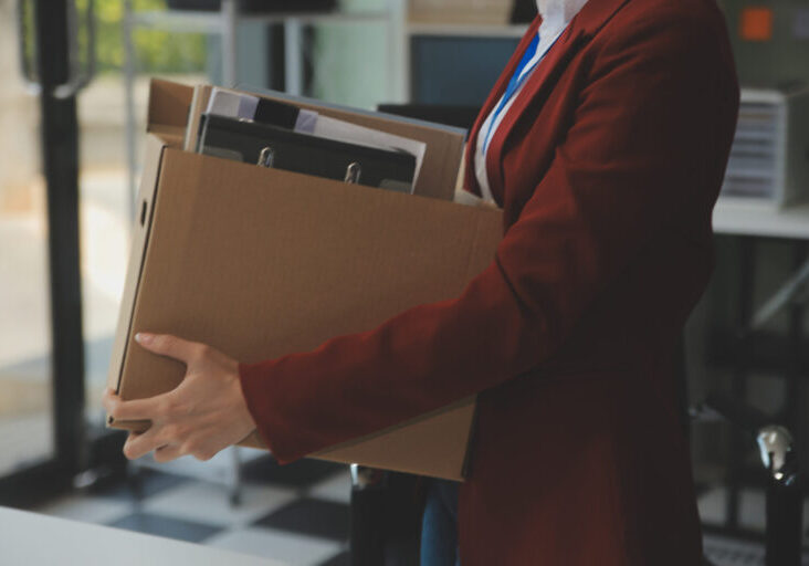 Businesswoman packing her things for move Businesswoman packing her things for move