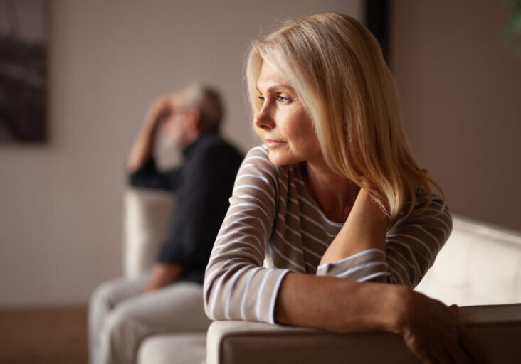 The older couple has a conflict. Upset mature woman, quarrel with her husband. Relationship crisis.