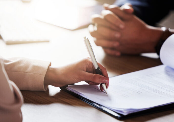 Business people, hands and signing contract, form or application for hire, recruitment or policy on table. Hand of person writing or filling in paperwork with pen for deal, agreement or information Business people, hands and signing contract, form or application for hire, recruitment or policy on table. Hand of person writing or filling in paperwork with pen for deal, agreement or information